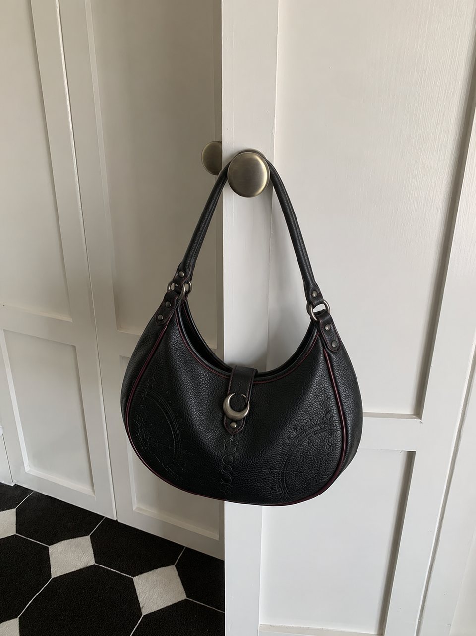 Black crescent shoulder bag with a moon clasp